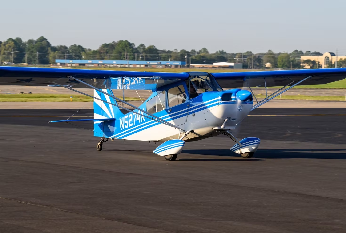 Blue and white propeller aircraft on the ramp